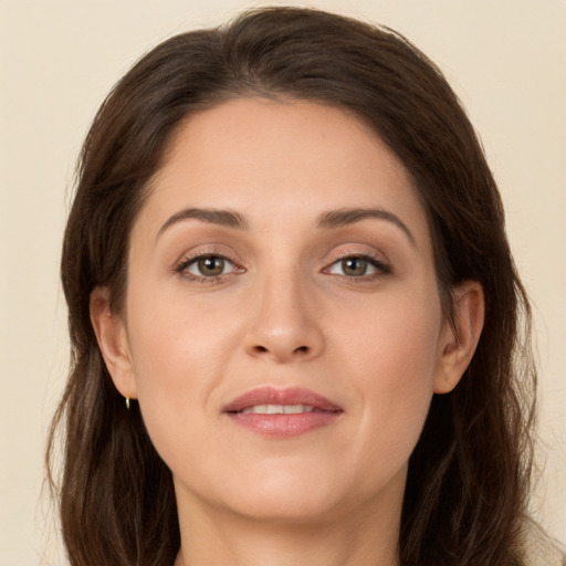 Joyful white young-adult female with long  brown hair and grey eyes