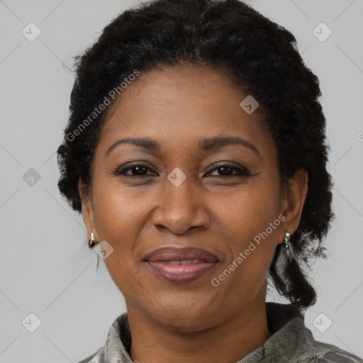 Joyful black adult female with short  brown hair and brown eyes