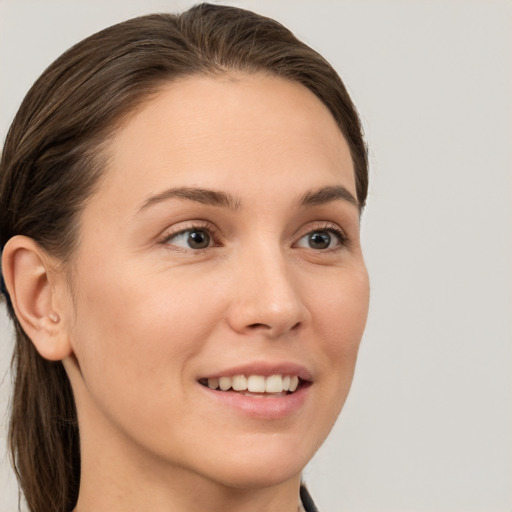 Joyful white young-adult female with medium  brown hair and brown eyes