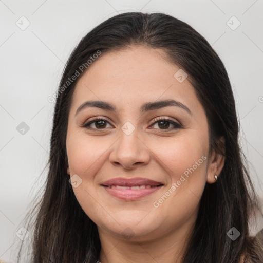 Joyful latino young-adult female with long  brown hair and brown eyes