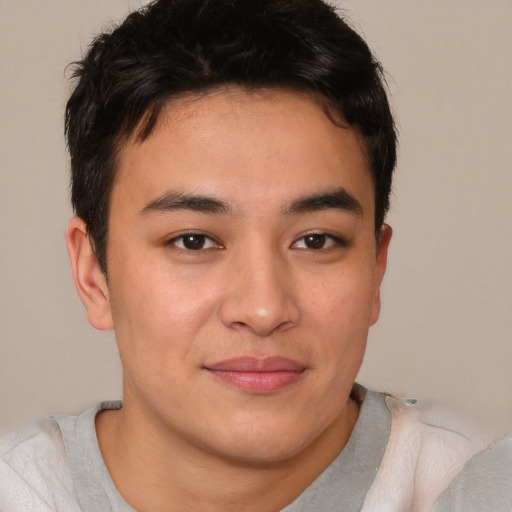 Joyful asian young-adult male with short  brown hair and brown eyes