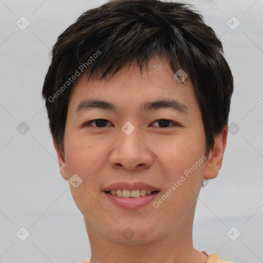 Joyful asian young-adult male with short  brown hair and brown eyes