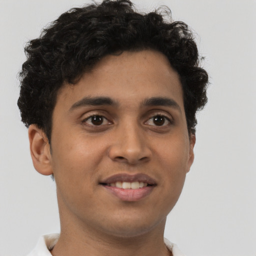Joyful latino young-adult male with short  brown hair and brown eyes