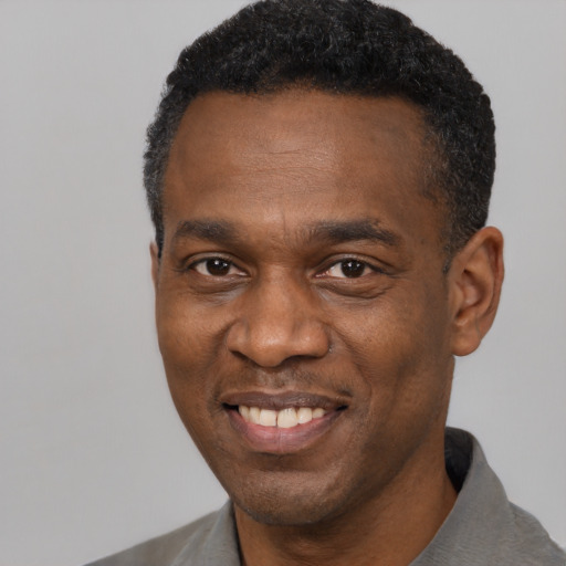Joyful latino adult male with short  black hair and brown eyes