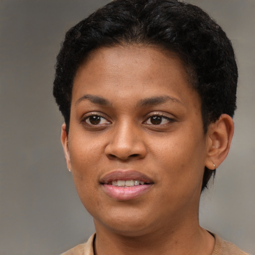 Joyful black young-adult female with short  brown hair and brown eyes