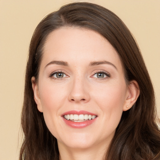 Joyful white young-adult female with long  brown hair and brown eyes