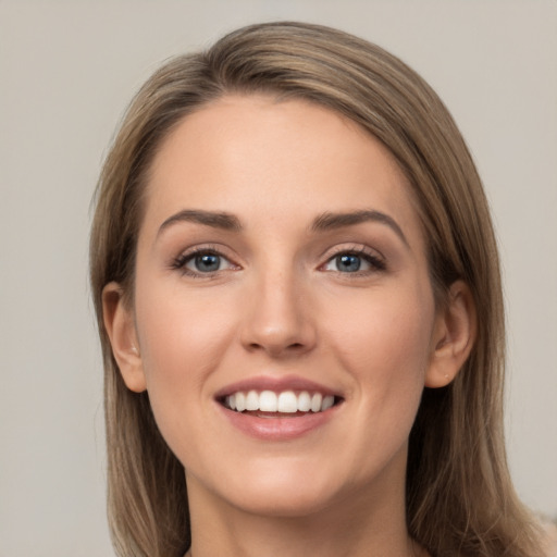 Joyful white young-adult female with long  brown hair and grey eyes