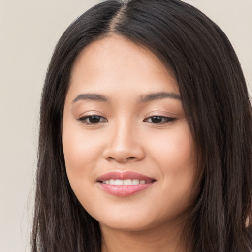 Joyful white young-adult female with long  black hair and brown eyes