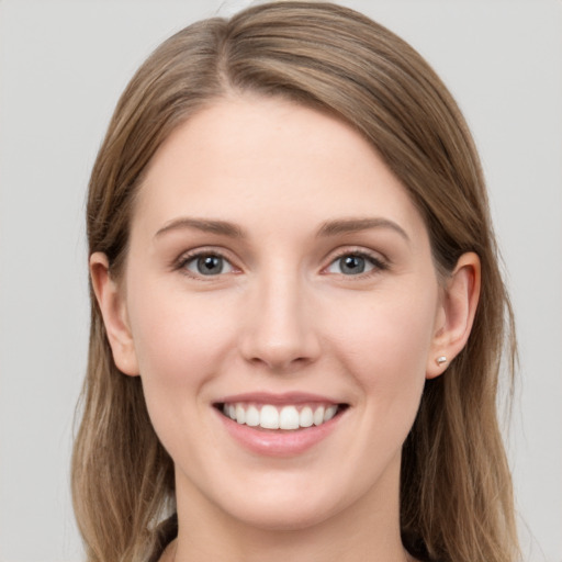 Joyful white young-adult female with long  brown hair and grey eyes