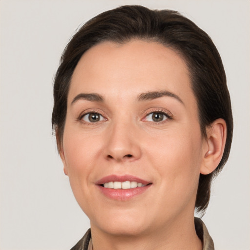 Joyful white young-adult female with medium  brown hair and brown eyes