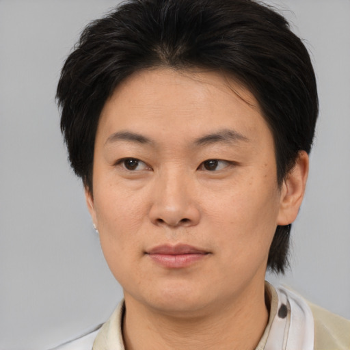 Joyful asian young-adult female with short  brown hair and brown eyes