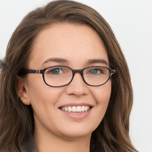 Joyful white young-adult female with long  brown hair and blue eyes