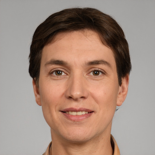 Joyful white adult male with short  brown hair and grey eyes