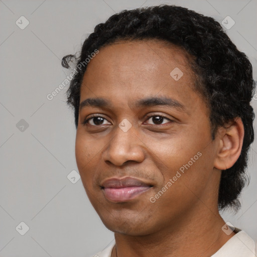 Joyful black young-adult male with short  black hair and brown eyes