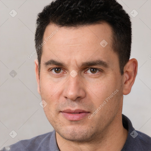 Joyful white young-adult male with short  black hair and brown eyes