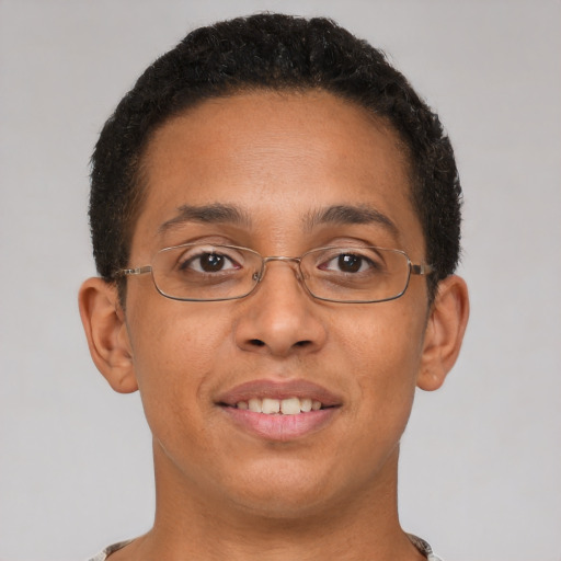 Joyful latino young-adult male with short  brown hair and brown eyes