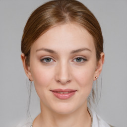 Joyful white young-adult female with medium  brown hair and blue eyes