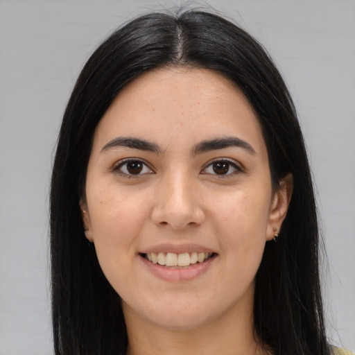 Joyful white young-adult female with long  black hair and brown eyes