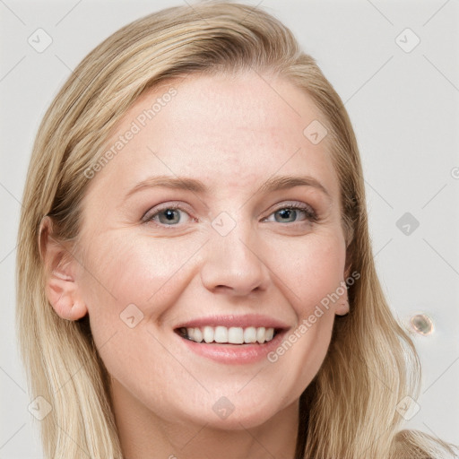 Joyful white young-adult female with long  brown hair and blue eyes