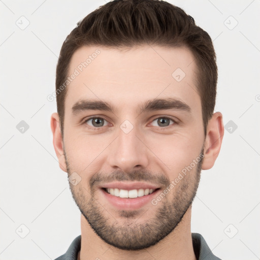 Joyful white young-adult male with short  brown hair and brown eyes