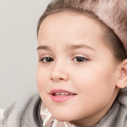 Joyful white child female with short  brown hair and brown eyes