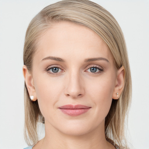 Joyful white young-adult female with long  brown hair and blue eyes