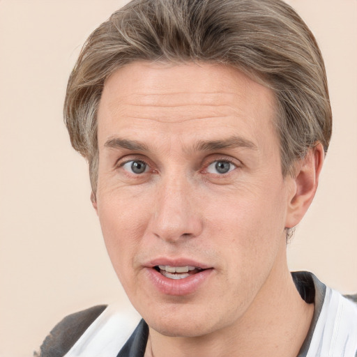 Joyful white adult male with short  brown hair and grey eyes