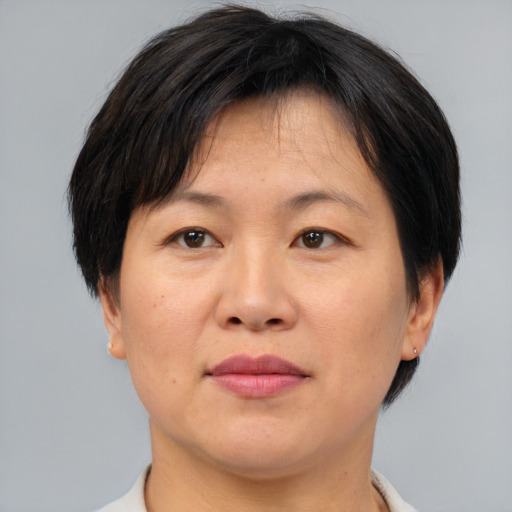 Joyful asian adult female with medium  brown hair and brown eyes