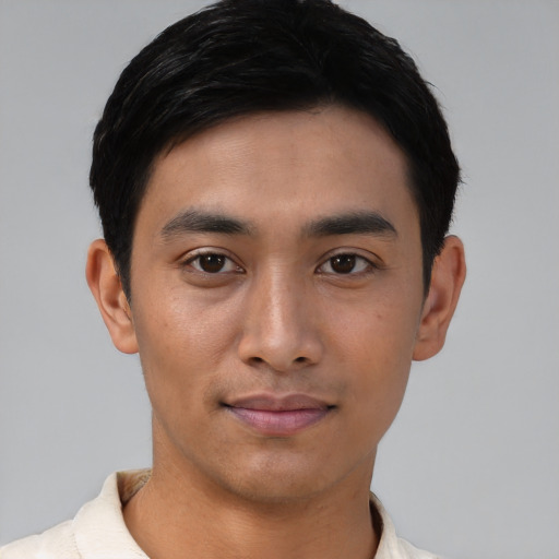 Joyful asian young-adult male with short  black hair and brown eyes