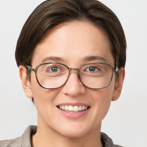 Joyful white adult female with short  brown hair and grey eyes