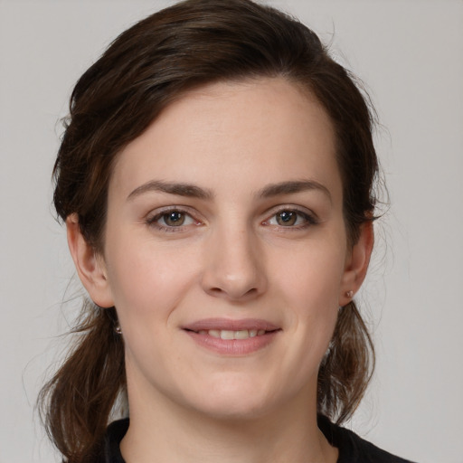 Joyful white young-adult female with medium  brown hair and brown eyes