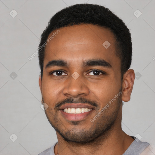 Joyful black young-adult male with short  black hair and brown eyes