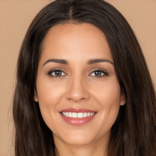 Joyful white young-adult female with long  brown hair and brown eyes