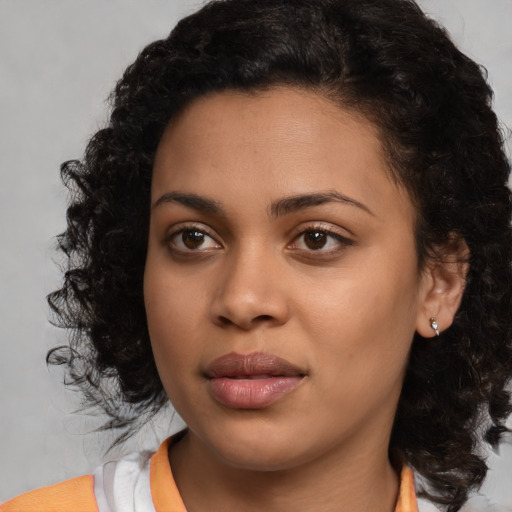 Joyful latino young-adult female with medium  black hair and brown eyes