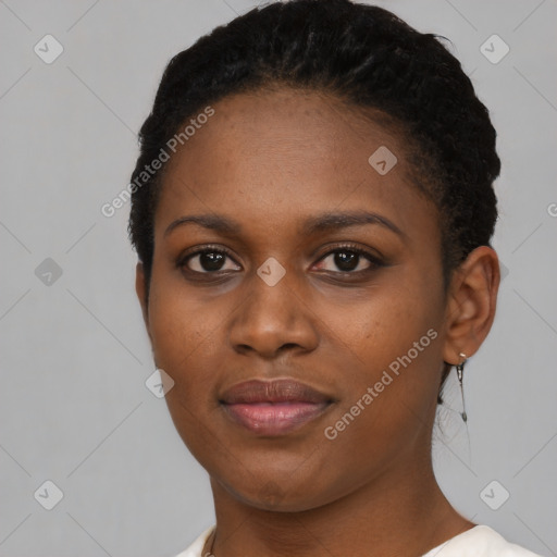 Joyful black young-adult female with short  black hair and brown eyes