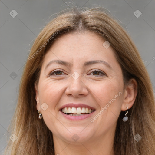 Joyful white adult female with long  brown hair and grey eyes