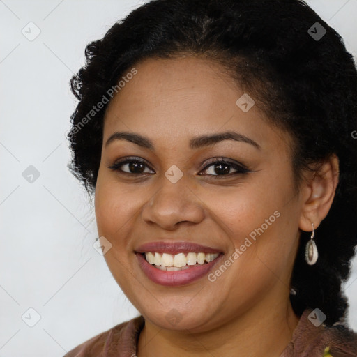 Joyful black young-adult female with long  brown hair and brown eyes