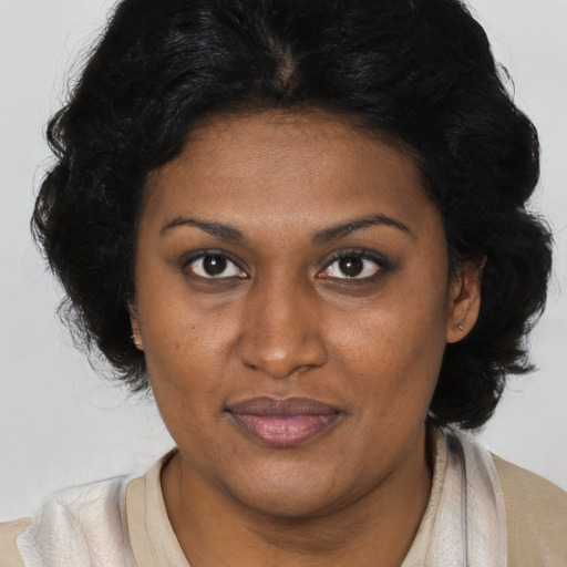 Joyful latino adult female with medium  brown hair and brown eyes