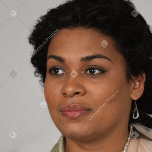 Joyful black young-adult female with long  black hair and brown eyes