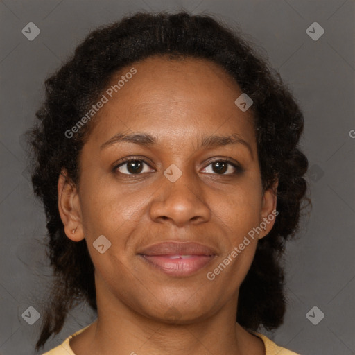 Joyful black adult female with medium  brown hair and brown eyes