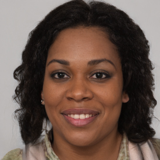 Joyful black young-adult female with medium  brown hair and brown eyes