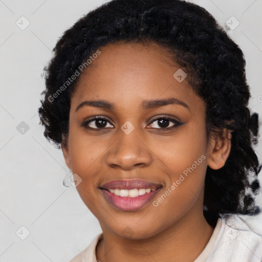 Joyful black young-adult female with long  black hair and brown eyes