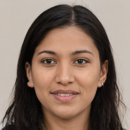 Joyful latino young-adult female with long  brown hair and brown eyes