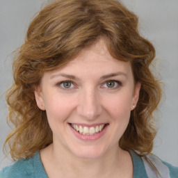 Joyful white young-adult female with medium  brown hair and blue eyes