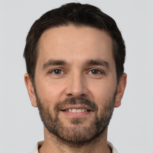 Joyful white adult male with short  brown hair and brown eyes