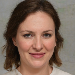 Joyful white adult female with medium  brown hair and brown eyes