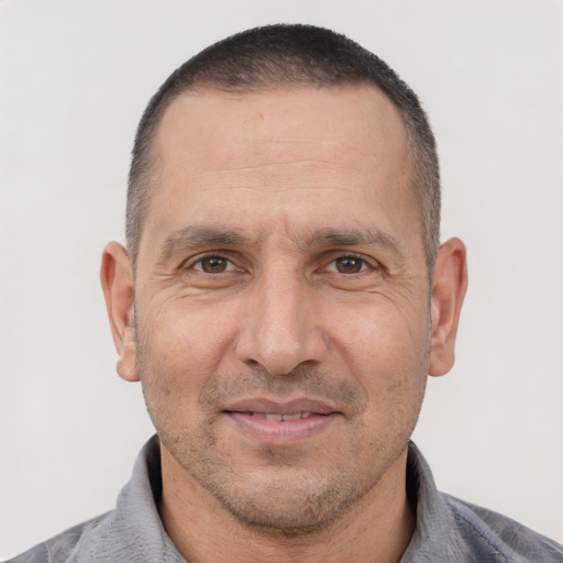 Joyful white adult male with short  brown hair and brown eyes