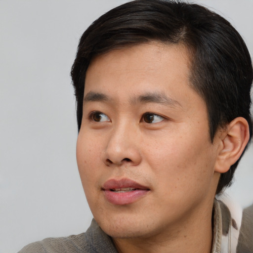 Neutral asian young-adult male with short  black hair and brown eyes