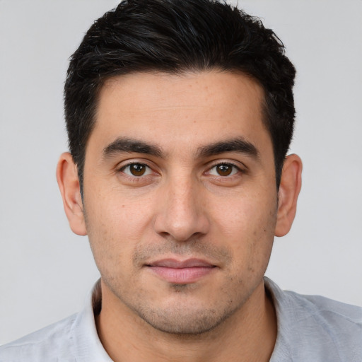 Joyful white young-adult male with short  brown hair and brown eyes