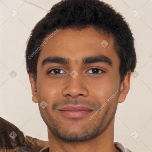 Joyful latino young-adult male with short  brown hair and brown eyes